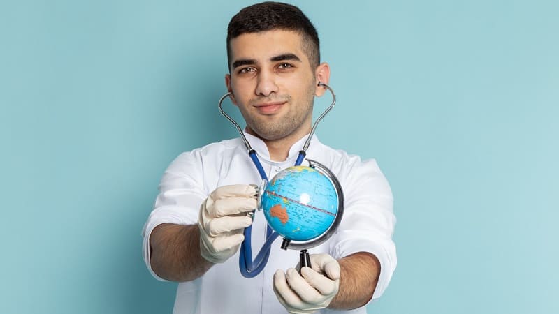 طبيب يحمل مجسّم الكرة الأرضية للدلالة على خدمات السياحة العلاجية في إسطنبول.